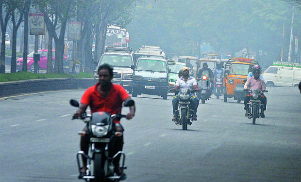 A file photo shows motorists drive through smog in city. A file photo shows motorists drive through smog in city.